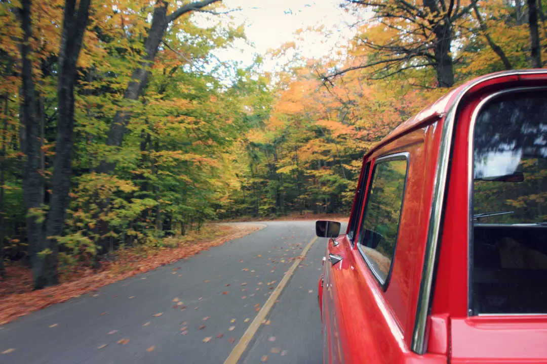 Autumn road trips to witness fall foliage are popular with American travelers.