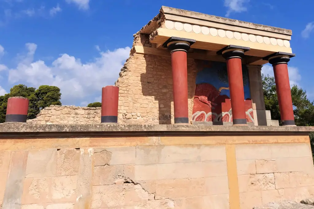Knossos Palace ancient Minoan ruins with reconstructed columns and stone structures, Crete
