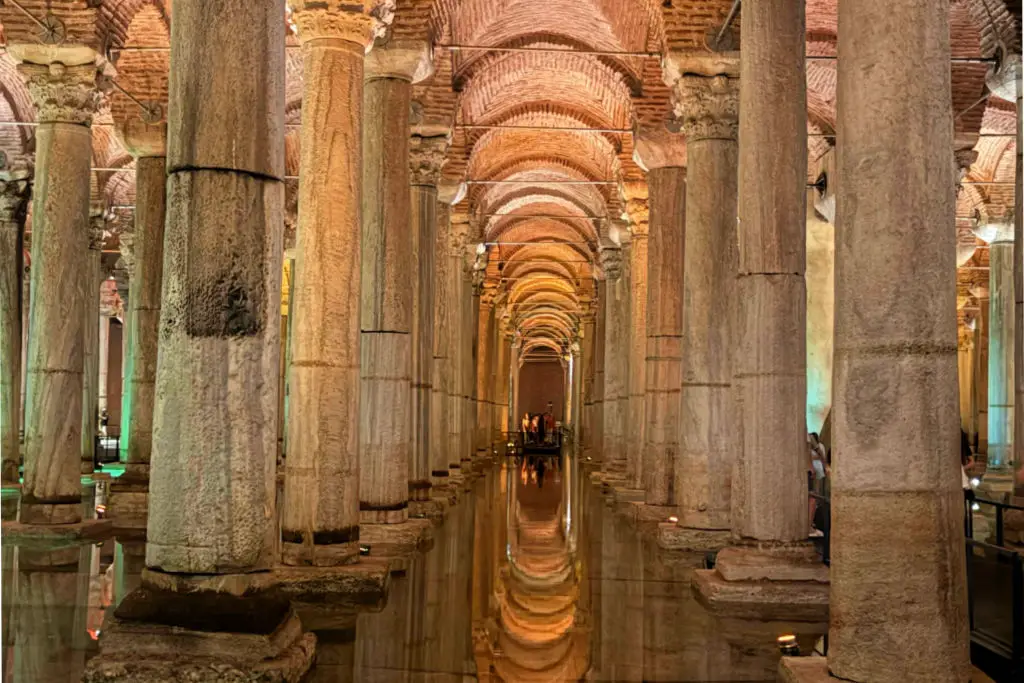 Basilica Cistern's cavernous interior with ancient stone columns reflected in still water, Istanbul Turkey