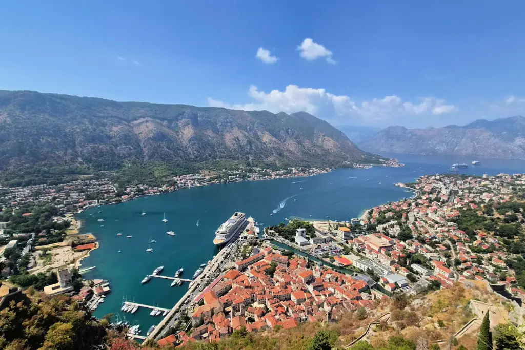 Bay of Kotor fjord-like waters with Kotor Old Town nestled at base of mountains, Montenegro