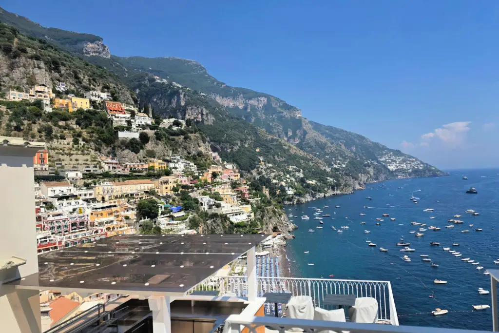 Positano cliffside buildings cascading down to the Amalfi Coast with Mediterranean Sea